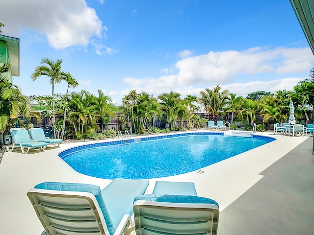 280 Monroe Ave, Cape Canaveral, FL 32920 - community pool with a fenced backyard and a patio