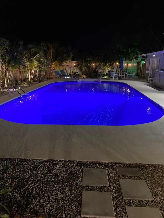 280 Monroe Ave, Cape Canaveral, FL 32920 - pool at night with an outdoor pool and a patio