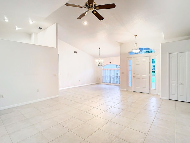 foyer with high vaulted ceiling, ceiling fan with notable chandelier, and light tile patterned floors