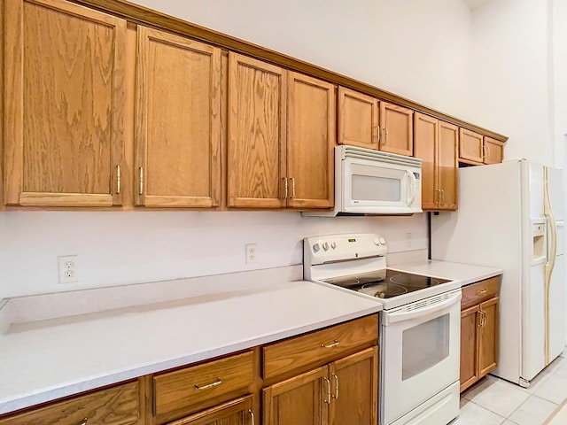 kitchen featuring white appliances and light tile patterned floors