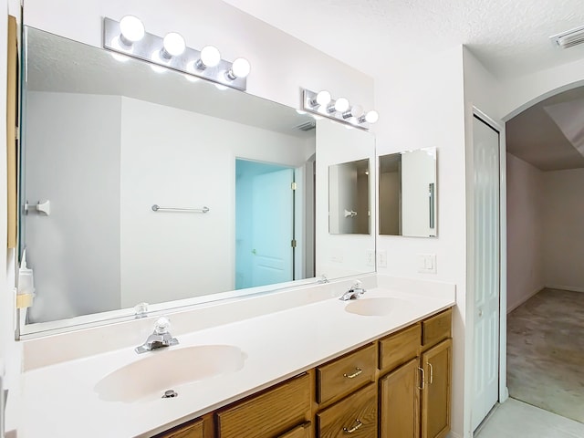 bathroom with vanity and a textured ceiling