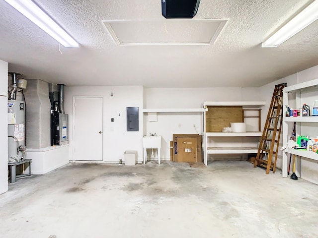 garage with heating unit, sink, gas water heater, and electric panel