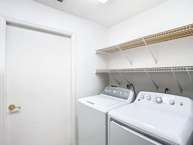 clothes washing area featuring washing machine and clothes dryer