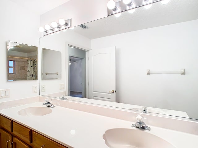 bathroom with vanity and curtained shower