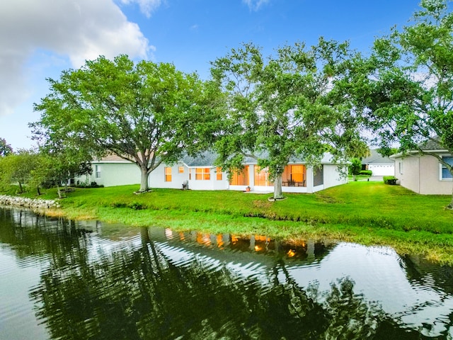 exterior space with a lawn and a water view