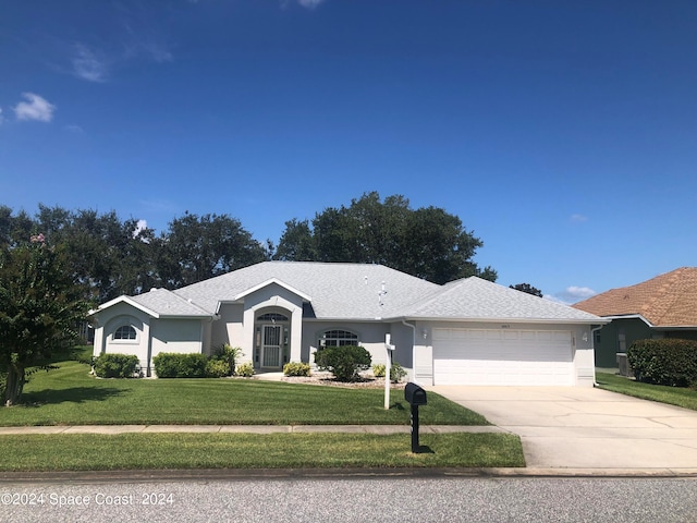 ranch-style house with a garage and a front yard