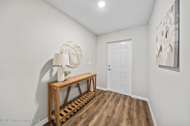 entryway with a textured ceiling and dark hardwood / wood-style floors