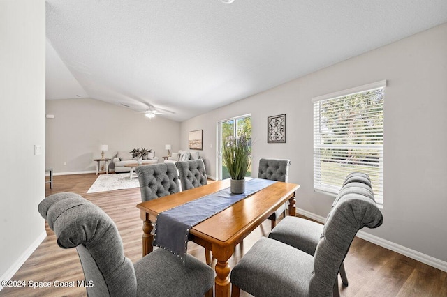 dining area with lofted ceiling, hardwood / wood-style floors, and ceiling fan