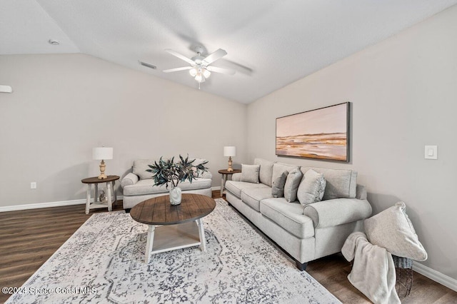 living room with ceiling fan, vaulted ceiling, and dark hardwood / wood-style flooring