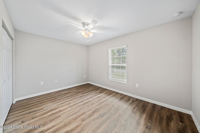 unfurnished bedroom with hardwood / wood-style floors, a textured ceiling, a closet, and ceiling fan