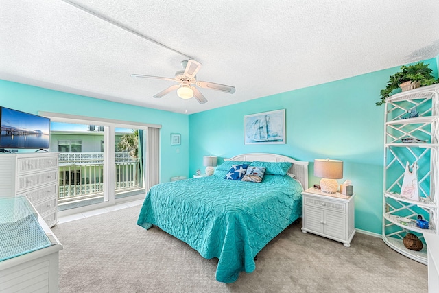 bedroom with ceiling fan, a textured ceiling, light carpet, and access to outside