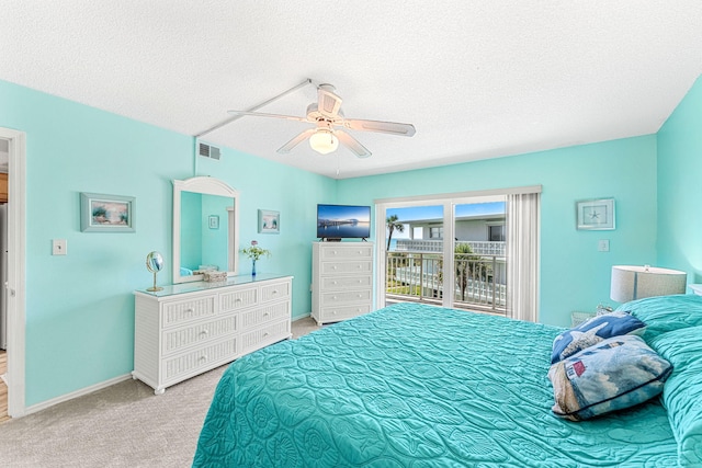 bedroom featuring access to outside, a textured ceiling, carpet floors, and ceiling fan