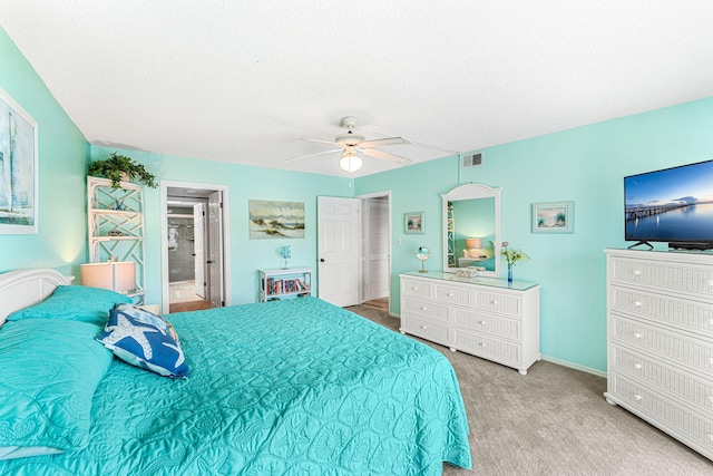 bedroom featuring carpet, ceiling fan, and a textured ceiling