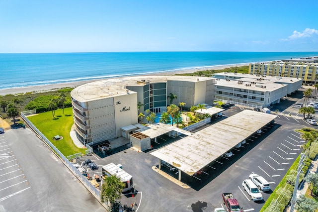 birds eye view of property featuring a beach view and a water view