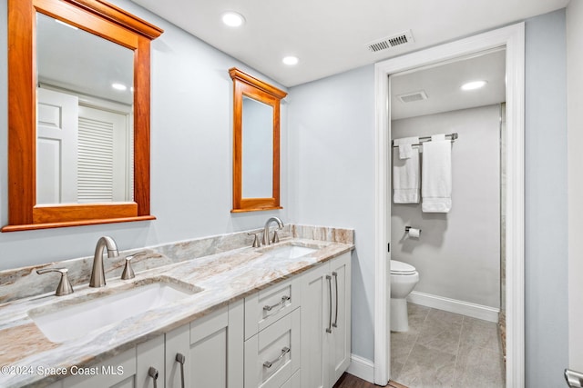 bathroom with vanity, toilet, and tile patterned floors