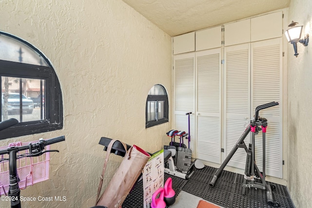 exercise area featuring a textured ceiling