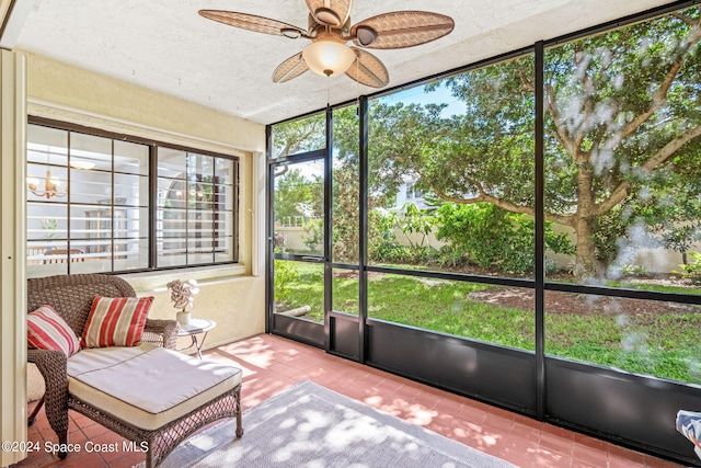 sunroom / solarium featuring a healthy amount of sunlight and ceiling fan