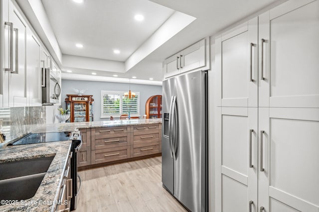 115 N Indian River Dr Unit 133, Cocoa, FL 32922 - kitchen featuring appliances with stainless steel finishes, white cabinets, light wood finished floors, recessed lighting, and light stone counters