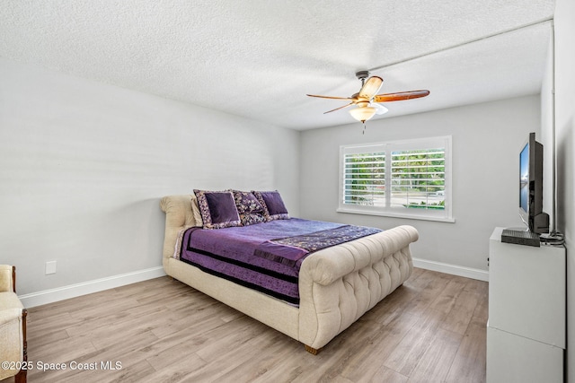 115 N Indian River Dr Unit 133, Cocoa, FL 32922 - bedroom featuring light wood finished floors, baseboards, a textured ceiling, and ceiling fan