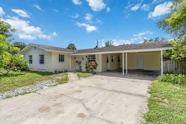 ranch-style house with a carport and a front yard