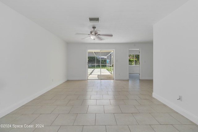 tiled spare room with ceiling fan