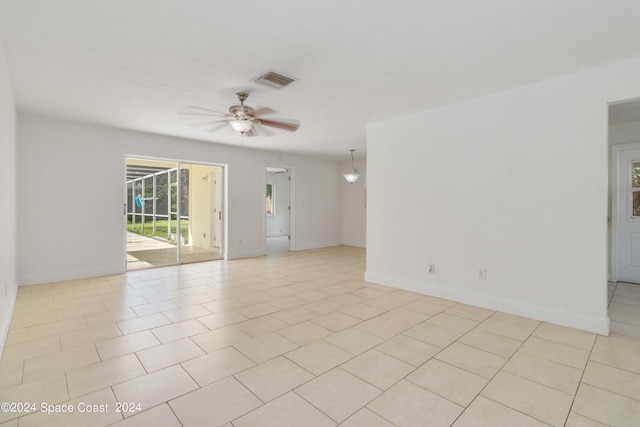 empty room with light tile patterned flooring and ceiling fan