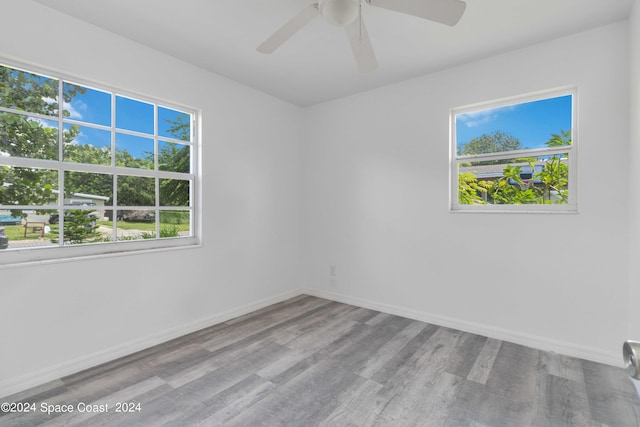 unfurnished room featuring ceiling fan and hardwood / wood-style floors