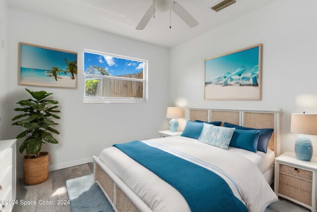 bedroom with ceiling fan and wood-type flooring