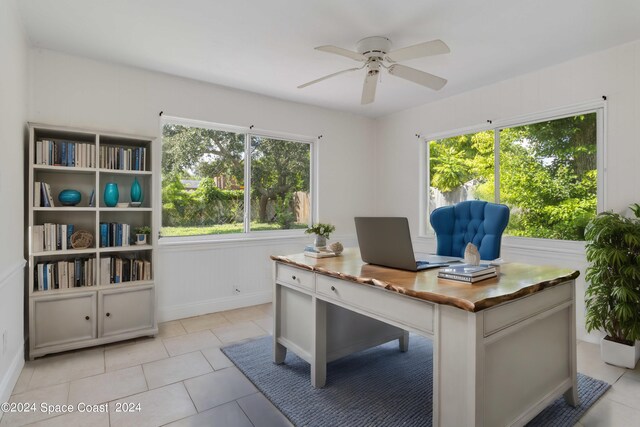 tiled office space featuring a healthy amount of sunlight and ceiling fan