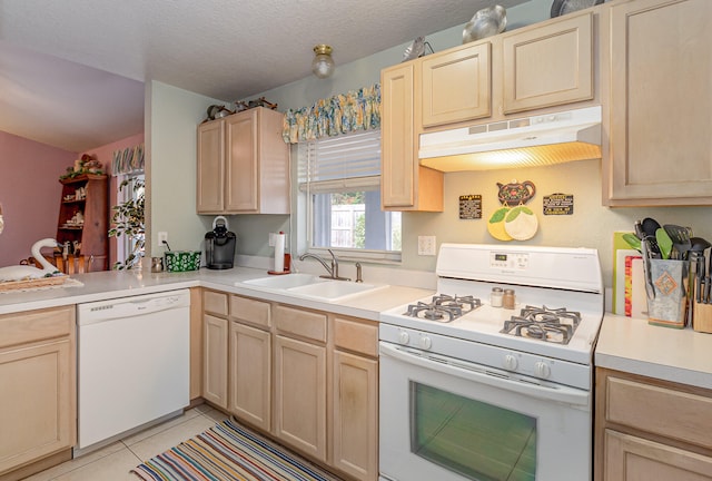 kitchen with white appliances, light brown cabinetry, a textured ceiling, light tile floors, and sink