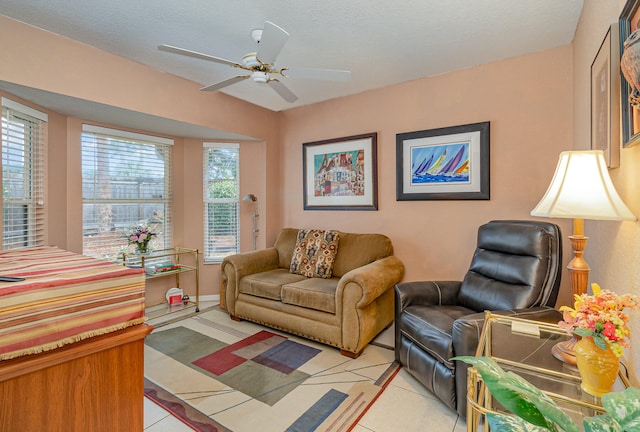 tiled living room featuring ceiling fan