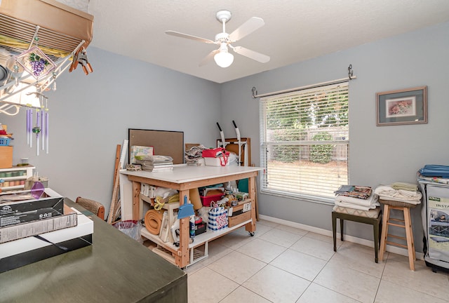 home office with ceiling fan and light tile flooring