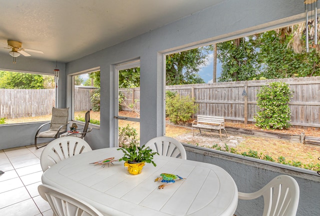 sunroom / solarium featuring ceiling fan