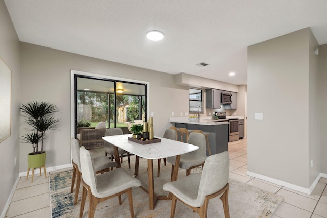 dining space featuring light tile floors