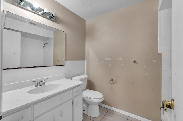 bathroom with tile flooring, tile walls, backsplash, toilet, and large vanity