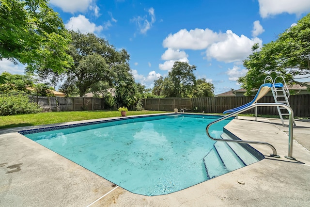 view of pool with a water slide and a yard