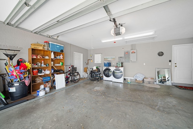 garage with washing machine and dryer and a garage door opener