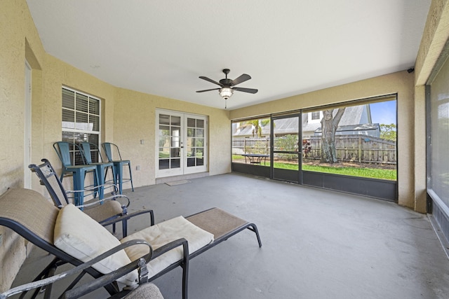 sunroom featuring ceiling fan and french doors