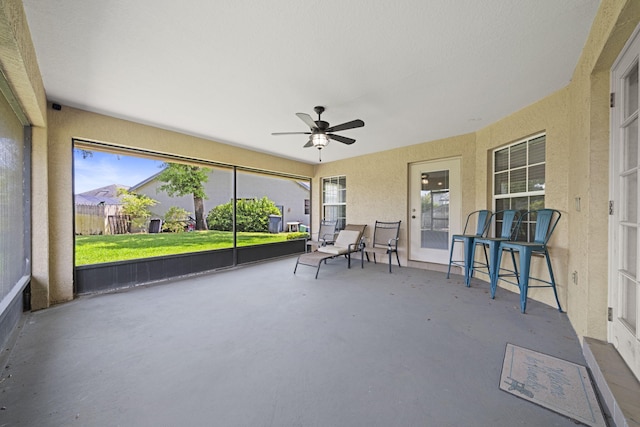 sunroom / solarium featuring ceiling fan