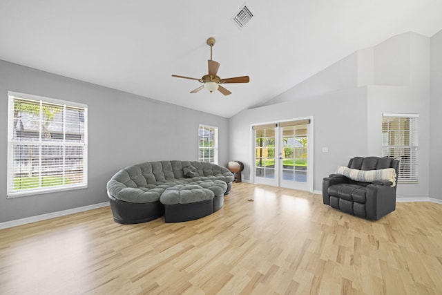 living room featuring high vaulted ceiling, ceiling fan, and light wood-type flooring