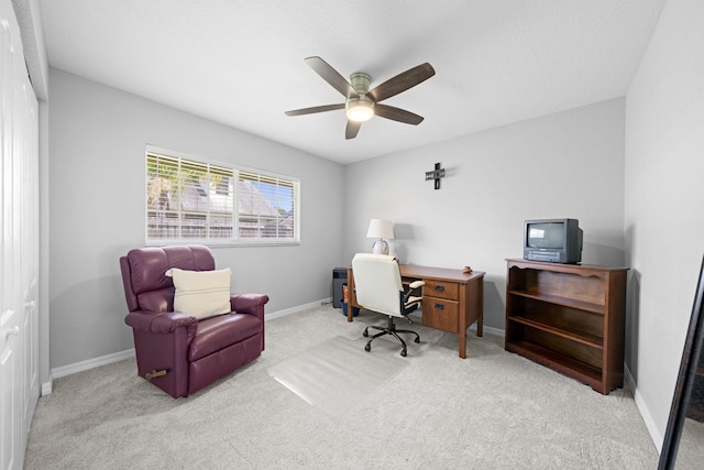 carpeted office with ceiling fan