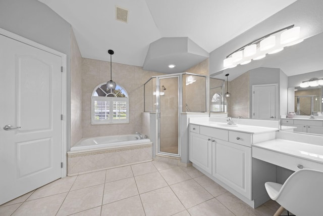 bathroom with tile flooring, vanity, and shower with separate bathtub