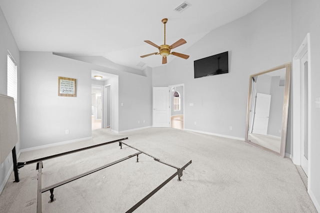 bedroom with high vaulted ceiling, light carpet, ensuite bath, and ceiling fan