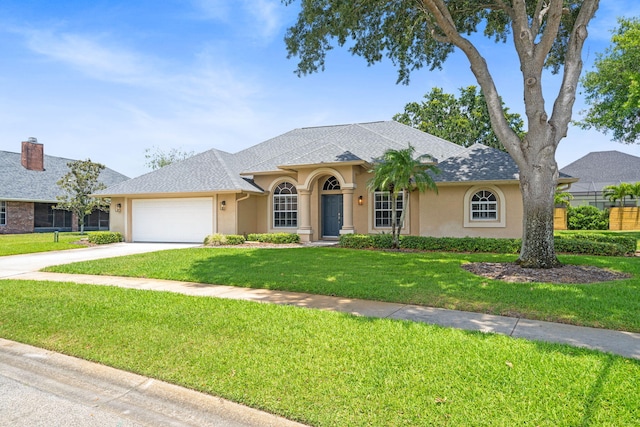 view of front facade featuring a garage and a front lawn