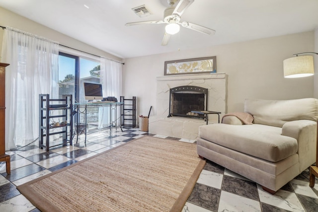 living room with tile flooring, a fireplace, and ceiling fan