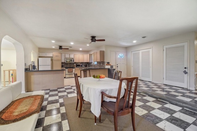 dining area featuring ceiling fan and light tile floors