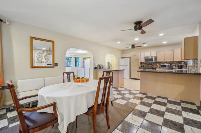 tiled dining space featuring sink and ceiling fan