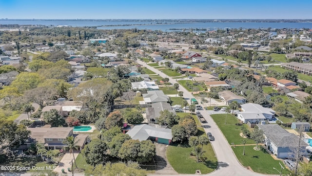 drone / aerial view featuring a residential view and a water view