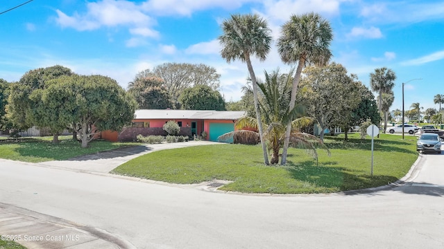 view of front of property with a garage, concrete driveway, and a front yard