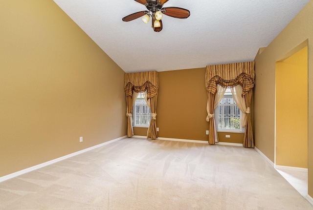 carpeted spare room with a textured ceiling and ceiling fan